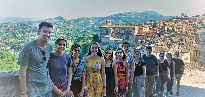 Summer study in Perugia students on a hillside overlooking the city.