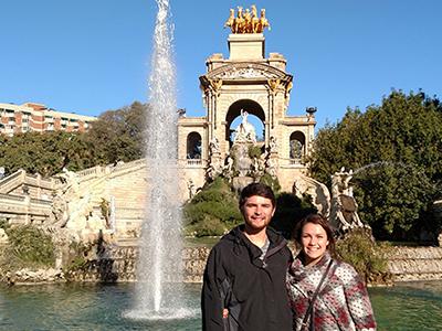 Two study abroad students by a fountain in Seville, Spain